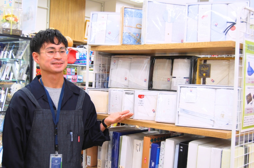 タオルギフトの前に説明する店員